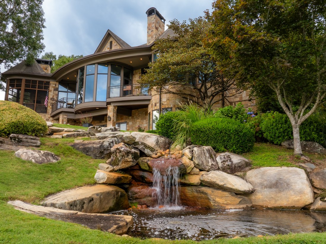 The waterfall running through boulders into the koi pond